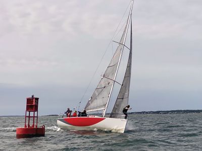 Salty 100 Regatta
Red Shift reaches the finish line of the inaugural Salty 100 regatta, raced August 27-28 from Marion harbor beyond Point Judith, Rhode Island, and back. Red Shift, skippered by Jo Riley of Massachusetts Maritime Academy, finished the race in 21 hours, 14 minutes and 15 seconds and was runner-up among the 11 boats in the PHRF 145 class. The winner was Piper Lance, skippered by Brian Sager of the Beverly Yacht Club, finishing in 20:57:37. Photo by Becky Tougas
