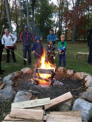 Salty's Silvery Moon Soiree
On the evening of October 23, the Mattapoisett Land Trust hosted its annual Salty’s Silvery Moon Soiree at Dunseith Gardens. The yearly autumn event finds families gathering around a roaring fire pit and toasting marshmallows or creating delicious desserts while listening to live music. On this night, music was provided by Jeff Dunn, and storyteller Danny Dullea entertained all with marvelous tales about the natural world. Photos by Marilou Newell
