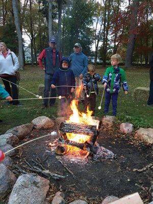 Salty's Silvery Moon Soiree
On the evening of October 23, the Mattapoisett Land Trust hosted its annual Salty’s Silvery Moon Soiree at Dunseith Gardens. The yearly autumn event finds families gathering around a roaring fire pit and toasting marshmallows or creating delicious desserts while listening to live music. On this night, music was provided by Jeff Dunn, and storyteller Danny Dullea entertained all with marvelous tales about the natural world. Photos by Marilou Newell
