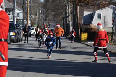 Santa Run 
Saturday, December 7, was the Santa Run 5k through the village of Mattapoisett. Usually held in New Bedford, race organizer Geoff Smith moved the race to Mattapoisett, flooding the village streets with hundreds of Santas – and a few Christmas miniature horses, as well. Photos by Jean Perry
