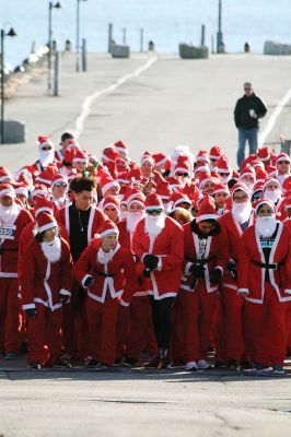 Santa Run 
Saturday, December 7, was the Santa Run 5k through the village of Mattapoisett. Usually held in New Bedford, race organizer Geoff Smith moved the race to Mattapoisett, flooding the village streets with hundreds of Santas – and a few Christmas miniature horses, as well. Photos by Jean Perry
