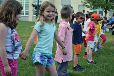 Field Day Fun at Sippican School 
Friday morning we caught some first-graders in the middle of a hula-hoop relay on the grounds of Sippican School. Holding hands and cheering each other on, the kids twisted and turned themselves through the hoops and the first team to get their hoop to travel down and up the line again won the relay. Can you guess which team won? Photo by Jean Perry
