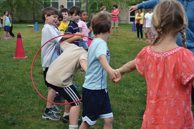 Field Day Fun at Sippican School 
Friday morning we caught some first-graders in the middle of a hula-hoop relay on the grounds of Sippican School. Holding hands and cheering each other on, the kids twisted and turned themselves through the hoops and the first team to get their hoop to travel down and up the line again won the relay. Can you guess which team won? Photo by Jean Perry
