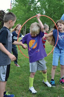 Field Day Fun at Sippican School 
Friday morning we caught some first-graders in the middle of a hula-hoop relay on the grounds of Sippican School. Holding hands and cheering each other on, the kids twisted and turned themselves through the hoops and the first team to get their hoop to travel down and up the line again won the relay. Can you guess which team won? Photo by Jean Perry
