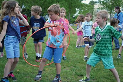 Field Day Fun at Sippican School 
Friday morning we caught some first-graders in the middle of a hula-hoop relay on the grounds of Sippican School. Holding hands and cheering each other on, the kids twisted and turned themselves through the hoops and the first team to get their hoop to travel down and up the line again won the relay. Can you guess which team won? Photo by Jean Perry
