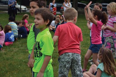 Field Day Fun at Sippican School 
Friday morning we caught some first-graders in the middle of a hula-hoop relay on the grounds of Sippican School. Holding hands and cheering each other on, the kids twisted and turned themselves through the hoops and the first team to get their hoop to travel down and up the line again won the relay. Can you guess which team won? Photo by Jean Perry
