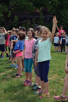 Field Day Fun at Sippican School 
Friday morning we caught some first-graders in the middle of a hula-hoop relay on the grounds of Sippican School. Holding hands and cheering each other on, the kids twisted and turned themselves through the hoops and the first team to get their hoop to travel down and up the line again won the relay. Can you guess which team won? Photo by Jean Perry
