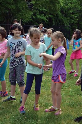 Field Day Fun at Sippican School 
Friday morning we caught some first-graders in the middle of a hula-hoop relay on the grounds of Sippican School. Holding hands and cheering each other on, the kids twisted and turned themselves through the hoops and the first team to get their hoop to travel down and up the line again won the relay. Can you guess which team won? Photo by Jean Perry
