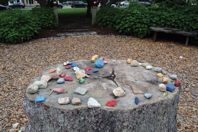 Sippican Elementary School
Colored stones sit atop and around the table-top tree stump at the center of the Memorial Garden in front of Sippican Elementary School. Photo by Mick Colageo

