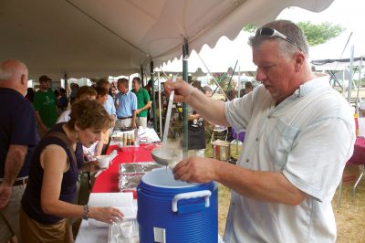 Summer Sizzler 
Mattapoisett resident Ken Dawicki (right) his signature seafood chowder to the Men Who Cook event at Shipyard Park on Sunday, July 15, 2012. Photo by Eric Tripoli
