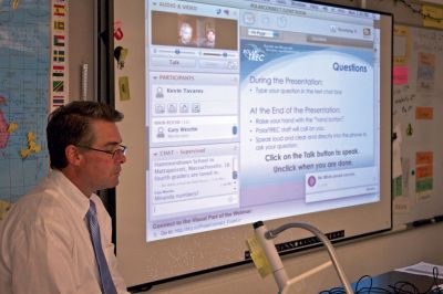 World Science
Old Hammondtown School fourth grade teacher Kevin Tavares (left) monitors a webinar that he and his students participated in on Monday, April 23, 2012.  They, along with people checking in from around the US and Canada, listened to two scientists in Greenland explain the work they do studying the Earth’s cryosphere. Tavares has been including interactive use of technology as a regular part of his students’ education. Photo By Eric Tripoli.
