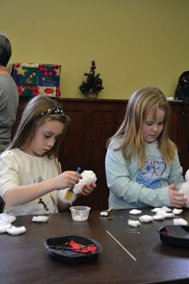 Build-your-own Snowman
Under the direction of Jeanne McCullough, children at the Mattapoisett Free Library on December 30 participated in a step-by-step build-your-own snowperson activity during the winter school break. Little fingers sticky with glue flattened out cotton balls and fastened them to prefabricated Styrofoam snowperson shapes, and then glued on the trimmings under the guidance of caregivers. Photos by Jean Perry
