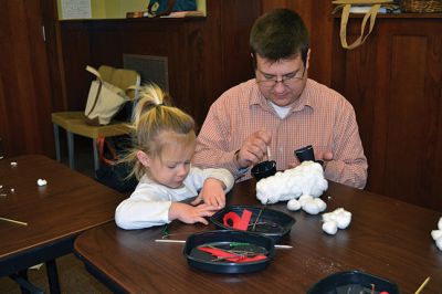 Build-your-own Snowman
Under the direction of Jeanne McCullough, children at the Mattapoisett Free Library on December 30 participated in a step-by-step build-your-own snowperson activity during the winter school break. Little fingers sticky with glue flattened out cotton balls and fastened them to prefabricated Styrofoam snowperson shapes, and then glued on the trimmings under the guidance of caregivers. Photos by Jean Perry
