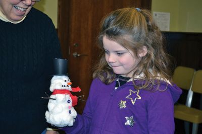 Build-your-own Snowman
Under the direction of Jeanne McCullough, children at the Mattapoisett Free Library on December 30 participated in a step-by-step build-your-own snowperson activity during the winter school break. Little fingers sticky with glue flattened out cotton balls and fastened them to prefabricated Styrofoam snowperson shapes, and then glued on the trimmings under the guidance of caregivers. Photos by Jean Perry
