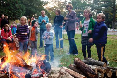 Salty Soiree
Before sitting down to listen to spooky songs and ghost stories, kids got to make s’mores and drink apple cider at the annual Salty Soiree, organized by the Mattapoisett Land Trust.  Photo by Eric Tripoli.
