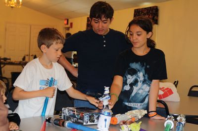 Star Wars Fans
Local young Star Wars fans gathered in Rochester at the Congregational Church on July 18 for a Star Wars symposium, hosted by Star Wars expert Peter Struzziero and sponsored by the Plumb Library. Pictured in descending order left to right: Dylan Hathaway, Bridget Farias, Ryan Farias, Andrew Ronsky, Molly Ronsky, Jack Ronsky, Nicholas Miedemar, and Rebecca York. Photo by Jean Perry
