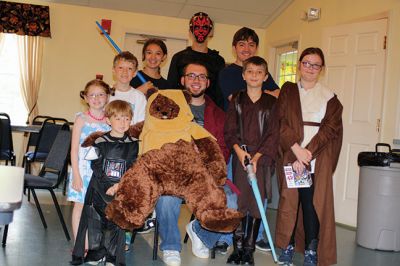 Star Wars Fans
Local young Star Wars fans gathered in Rochester at the Congregational Church on July 18 for a Star Wars symposium, hosted by Star Wars expert Peter Struzziero and sponsored by the Plumb Library. Pictured in descending order left to right: Dylan Hathaway, Bridget Farias, Ryan Farias, Andrew Ronsky, Molly Ronsky, Jack Ronsky, Nicholas Miedemar, and Rebecca York. Photo by Jean Perry
