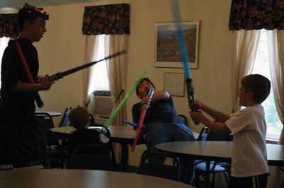 Star Wars Fans
Local young Star Wars fans gathered in Rochester at the Congregational Church on July 18 for a Star Wars symposium, hosted by Star Wars expert Peter Struzziero and sponsored by the Plumb Library. Pictured in descending order left to right: Dylan Hathaway, Bridget Farias, Ryan Farias, Andrew Ronsky, Molly Ronsky, Jack Ronsky, Nicholas Miedemar, and Rebecca York. Photo by Jean Perry
