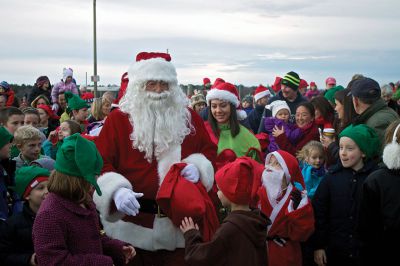 Marion Holiday Stroll
Santa Claus sped into the harbor on a boat and was greeted by hundreds of kids and their families who were eagerly awaiting his arrival on the pier.  Due to heavy rain last year, turnout was especially strong on Sunday.  Photo by Eric Tripoli.
