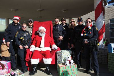 Stuff a Cruiser
Willie enjoys a moment with the 1924 Model T, and Santa Claus is joined by Marion Chief of Police Richard Nighelli and his daughter Kayla as the Marion Police Department and Marion Police Brotherhood collaborated for their annual Stuff a Cruiser event at the Sippican Elementary School’s bus loop. 
