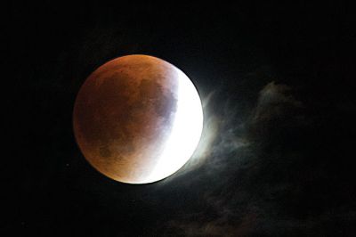 Supermoon Eclipse
A blood red Harvest Moon hangs above Ned’s Point in Mattapoisett where some people had a stellar view of the rare celestial event of a total lunar eclipse of a supermoon. Dozens came to watch the moon on Sunday night as it passed through the Earth’s shadow between 9:07 pm, when the partial eclipse began, and 12:27 am when the spectacle ended. Photo by Colin Veitch
