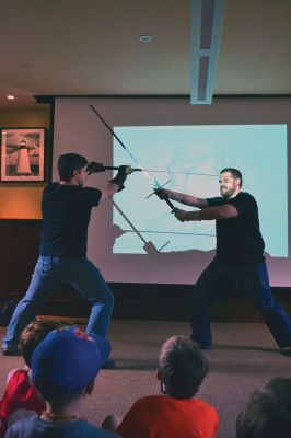 Cold Steel
“Cold Steel” was one of the educating and exciting free programs the Mattapoisett Free Library offers during the summer. Visitors learned all about the history of swords and the origins of sword fighting, while Jeff Lord and Jeff Goodkind from the Association for Renaissance and Medieval Swordsmanship gave live demonstrations before a crowd of enthusiastic kids and adults. Photos by Jean Perry
