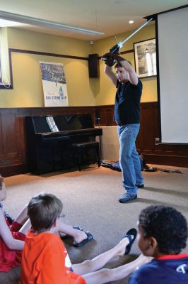 Cold Steel
“Cold Steel” was one of the educating and exciting free programs the Mattapoisett Free Library offers during the summer. Visitors learned all about the history of swords and the origins of sword fighting, while Jeff Lord and Jeff Goodkind from the Association for Renaissance and Medieval Swordsmanship gave live demonstrations before a crowd of enthusiastic kids and adults. Photos by Jean Perry
