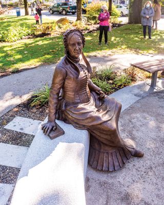 Elizabeth Taber Statue
A murky morning gave way to a sun-drenched celebration of Elizabeth Taber as the bronze statue of “Marion’s Fairy Godmother” was officially unveiled on October 17 in Bicentennial Park. Representatives from the Celebrate Elizabeth Taber Committee, Town of Marion officials, and sculptor Erik Durant addressed a large gathering of citizens who collected stickers and enjoyed music by the Academy Brass Quartet along with cupcakes. See story by Marilou Newell. Photo by Ryan Feeney - October 22, 2020 edition
