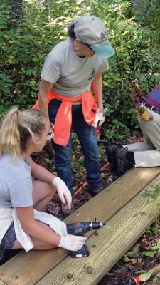 Tabor Academy “Day of Service”
As part of the Tabor Academy “Day of Service” on September 30, seven students – Gillan Campbell, Finn McCain, Tayler Rogers, Kyle Squires, Noah Tidus, Avaline Wilson, and Alex Zhang – along with teacher Roxie Bratton, helped the Sippican Lands Trust install 150 feet of additional bridging at The Shoolman Preserve. Pictured here: Tayler, Rosemary, & Mike assembling a bog bridge. Photo courtesy Tabor Academy
