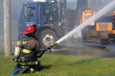 Trash Fire
A trash truck was up in smoke on Long Plain Road in Mattapoisett last week. Before I knew it, engines and firemen appeared in full gear. The Fire Department had the driver dump all the trash in a field near the road where the fire could be more safely extinguished. Photo by Ellie Higgins
