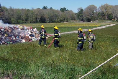 Trash Fire
A trash truck was up in smoke on Long Plain Road in Mattapoisett last week. Before I knew it, engines and firemen appeared in full gear. The Fire Department had the driver dump all the trash in a field near the road where the fire could be more safely extinguished. Photo by Ellie Higgins
