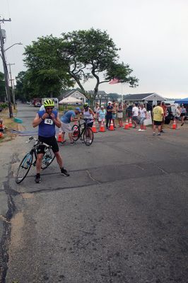 Mattapoisett Lions Club Triathlon
Emily Tato was grateful to Aner Larreategi after their top-three-overall performances in Sunday’s Mattapoisett Lions Club Triathlon. Pushed from start to finish by Larreategi, Tato was the fastest woman in all three events, the swim, bike and run. Don Cuddy was the 70-and-over winner. Photos by Mick Colageo
