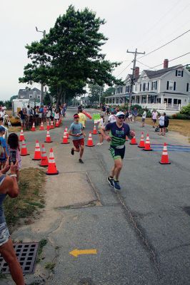 Mattapoisett Lions Club Triathlon
Emily Tato was grateful to Aner Larreategi after their top-three-overall performances in Sunday’s Mattapoisett Lions Club Triathlon. Pushed from start to finish by Larreategi, Tato was the fastest woman in all three events, the swim, bike and run. Don Cuddy was the 70-and-over winner. Photos by Mick Colageo
