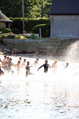 And They Are Off!
240 athletes kicked off the Harbor Days week on July 10, 2011 with the Mattapoisett Lions Triathlon, which started from Mattapoisett Town Beach and included a .25-mile swim, a 10-mile bike ride and a 3-mile run. The mens winner for the Triathlon was Keith Putnam or Marston Mills, MA with a time of 52:52, and the womens winner was Katie McCully of Eastham, MA with a time of 58:51. Photo by Anne Kakley. July 14, 2011 edition
