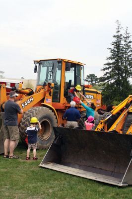 Second Annual Kid’s Equipment Day
Little kids and big, big machines on a warm spring Marion morning made for tons of fun at the Marion Recreation’s Second Annual Kid’s Equipment Day on May 10. A row of different Town-owned vehicles including a police cruiser, ambulance, earth diggers, a fire engine, and fire trucks lined the Town House field. There were plenty of Department of Public Works, police, and fire personnel on hand to demonstrate how the vehicles work, to turn on lights and alarms, and answer questions. Photo by Jean Perry
