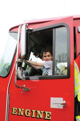 Second Annual Kid’s Equipment Day
Little kids and big, big machines on a warm spring Marion morning made for tons of fun at the Marion Recreation’s Second Annual Kid’s Equipment Day on May 10. A row of different Town-owned vehicles including a police cruiser, ambulance, earth diggers, a fire engine, and fire trucks lined the Town House field. There were plenty of Department of Public Works, police, and fire personnel on hand to demonstrate how the vehicles work, to turn on lights and alarms, and answer questions. Photo by Jean Perry
