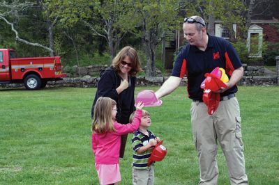 Second Annual Kid’s Equipment Day
Little kids and big, big machines on a warm spring Marion morning made for tons of fun at the Marion Recreation’s Second Annual Kid’s Equipment Day on May 10. A row of different Town-owned vehicles including a police cruiser, ambulance, earth diggers, a fire engine, and fire trucks lined the Town House field. There were plenty of Department of Public Works, police, and fire personnel on hand to demonstrate how the vehicles work, to turn on lights and alarms, and answer questions. Photo by Jean Perry
