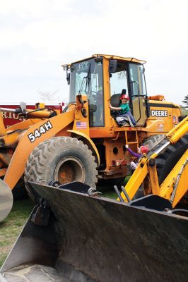 Second Annual Kid’s Equipment Day
Little kids and big, big machines on a warm spring Marion morning made for tons of fun at the Marion Recreation’s Second Annual Kid’s Equipment Day on May 10. A row of different Town-owned vehicles including a police cruiser, ambulance, earth diggers, a fire engine, and fire trucks lined the Town House field. There were plenty of Department of Public Works, police, and fire personnel on hand to demonstrate how the vehicles work, to turn on lights and alarms, and answer questions. Photo by Jean Perry
