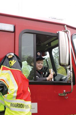 Second Annual Kid’s Equipment Day
Little kids and big, big machines on a warm spring Marion morning made for tons of fun at the Marion Recreation’s Second Annual Kid’s Equipment Day on May 10. A row of different Town-owned vehicles including a police cruiser, ambulance, earth diggers, a fire engine, and fire trucks lined the Town House field. There were plenty of Department of Public Works, police, and fire personnel on hand to demonstrate how the vehicles work, to turn on lights and alarms, and answer questions. Photo by Jean Perry
