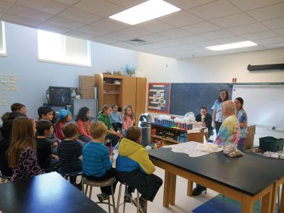 Tie Dye Fun
Students at the Marion Natural History After School Program learned about chemical reactions and colors during a tie-dye shirt-making session held this past week with UMass Dartmouth Chemistry Professor Tobey Dills. Photo courtesy of Elizabeth Leidhold
