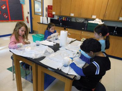 Tie Dye Fun
Students at the Marion Natural History After School Program learned about chemical reactions and colors during a tie-dye shirt-making session held this past week with UMass Dartmouth Chemistry Professor Tobey Dills. Photo courtesy of Elizabeth Leidhold
