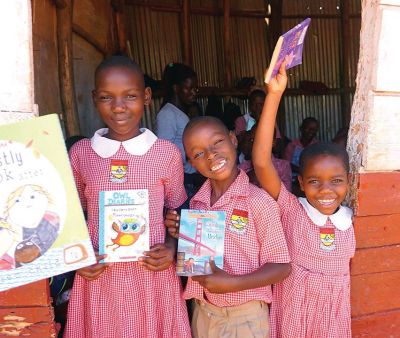 Kansanga Parents Primary School in Uganda
Students from the Kansanga Parents Primary School in Uganda hold donated books they received from students of Old Hammondtown School. The idea of providing a book for each of the 270 students was conceived by Ari Uhlin and her son Kai, with the help of Ari’s friend, Megan McMurrin, who lives in Uganda. Photos courtesy Megan McMurrin
