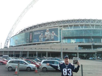 Pat vs. Buccaneers
Rochester Police Chief Paul Magee holds a copy of The Wanderer at Wembley Stadium in England on October 25 when the New England Patriots played the Tampa Bay Buccaneers. The Patriots won 35-7.
