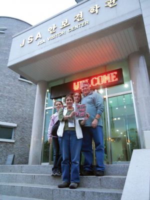 South Korea
While attending a recent wedding in South Korea, Rochester residents Spence, Marcy, Geneva, and Hannah Smith toured the United Nations Command Security Battalion-Joint Security Area which is located only 400 meters (1,300 feet) south of the southern boundary of the Demilitarized Zone.  Here, they are pictured with The Wanderer outside of the Welcome Center since they could only take cameras on the tour of Conference Row.
