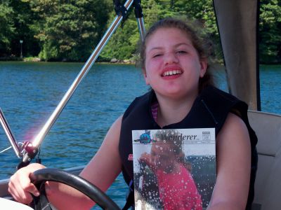 Lake George
While cruising on Lake George in a pontoon boat, Elizabeth knew texting while driving wasn’t allowed. Checking out the latest edition of the Wanderer however, was not prohibited.
