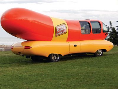 Wienermobile at Ned's Point
Those enjoying the afternoon at Ned’s Point Lighthouse on Sunday, August 17 did a double take when they suddenly saw a sight they were not expecting to see — a giant wiener on wheels parked alongside the Ned’s Point lighthouse. It was not just any wiener on wheels — it was the famous Oscar Mayer Wienermobile, on location taking some promotional photographs from Mattapoisett’s most iconic setting. Photo by Denise Mello
