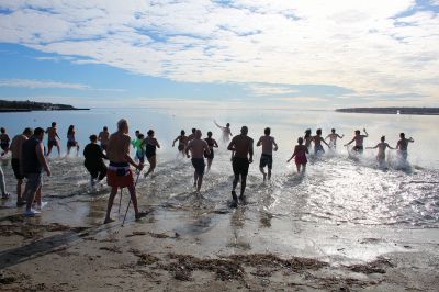 Christmas Day Plunge
At 94, Bob Humphrey was the elder statesman participating in the Christmas Day plunge held at Mattapoisett Town Beach, which including 47 swimmers and raised $2,595 in donations for the benefit of Helping Hands & Hooves. While December 25 was unseasonably mild, the water temperature in the harbor was still chilly as the effort inspired camaraderie among participating friends and couples. Photos by Mick Colageo
