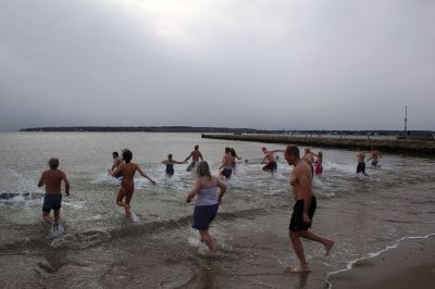 Christmas Plunge
An ice-cold Christmas morning in Mattapoisett did not stop citizens from jumping all the way into the waters of Mattapoisett Town Beach in support of Helping Hands and Hooves. Photos by Mick Colageo
