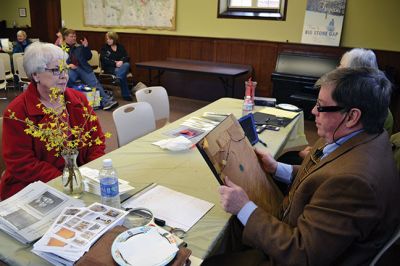 Library Treasures
Word spread of the Antiques Roadshow-style fundraiser at the Mattapoisett Library on March 29, attracting scores of South Coasters clutching their treasures, antiques, and heirlooms for appraisal and admiration, hoping Francis McNamee of the Marion Antique Shop might discover worth in their belongings beyond their sentimental value. Paying $5 per item appraised, some brought primitive dolls, old books, tea sets, and artwork. By Jean Perry
