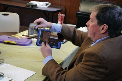 Library Treasures
Word spread of the Antiques Roadshow-style fundraiser at the Mattapoisett Library on March 29, attracting scores of South Coasters clutching their treasures, antiques, and heirlooms for appraisal and admiration, hoping Francis McNamee of the Marion Antique Shop might discover worth in their belongings beyond their sentimental value. Paying $5 per item appraised, some brought primitive dolls, old books, tea sets, and artwork. By Jean Perry
